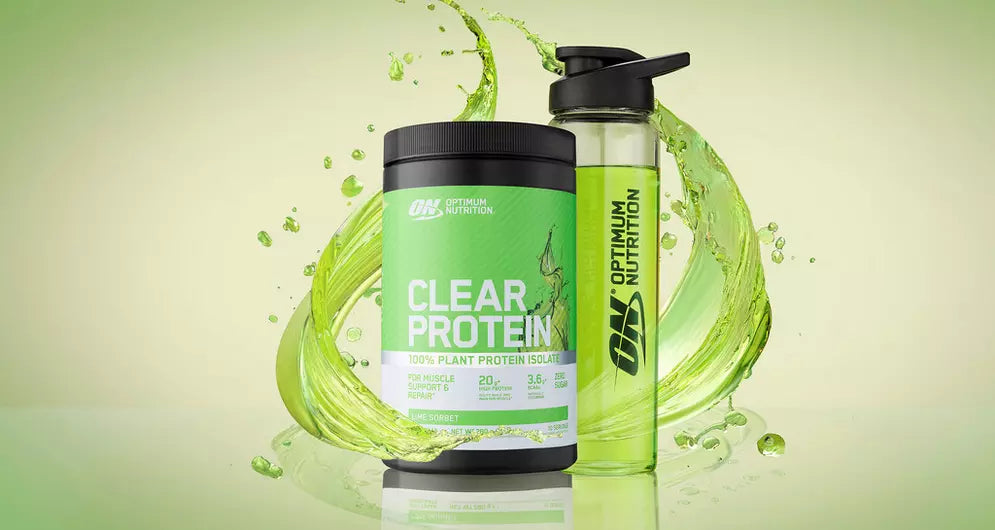 Optimum Nutrition Clear Protein tub alongside a shaker bottle with a splash of lime‑colored drink in the background.