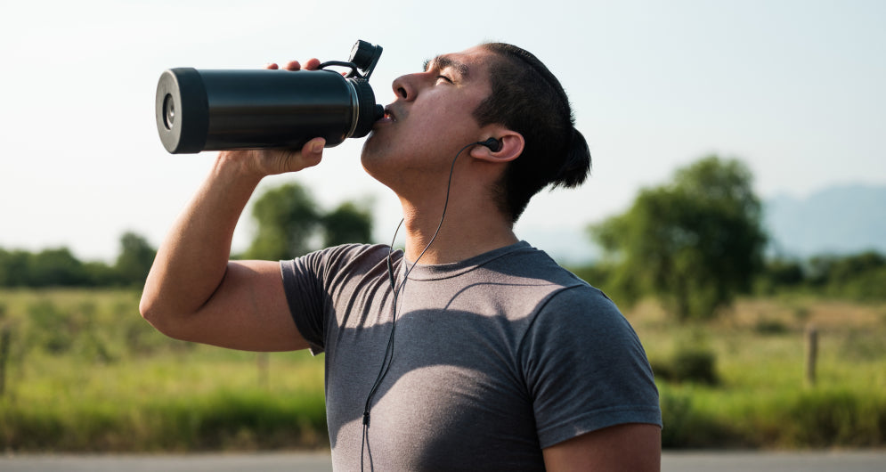 Man drinking protein shake outdoors
