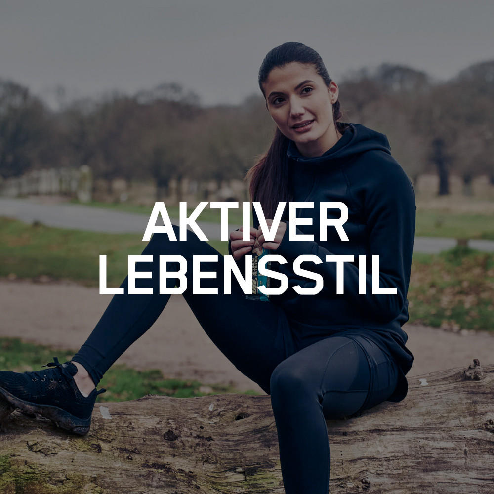 A person in athletic clothing sitting outdoors on a log, promoting an active lifestyle