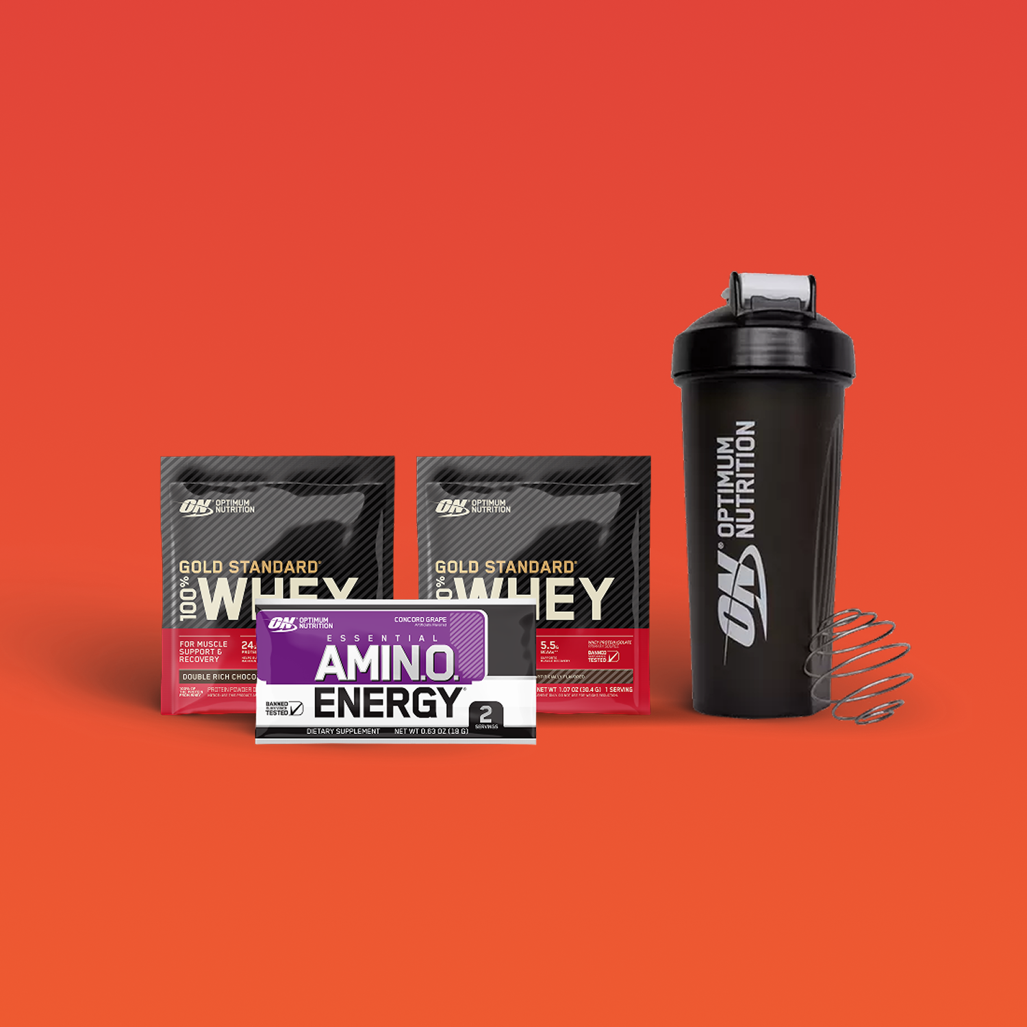 Optimum Nutrition Gold Standard 100% Whey Protein packets, Amino Energy sachet, and shaker bottle with whisk