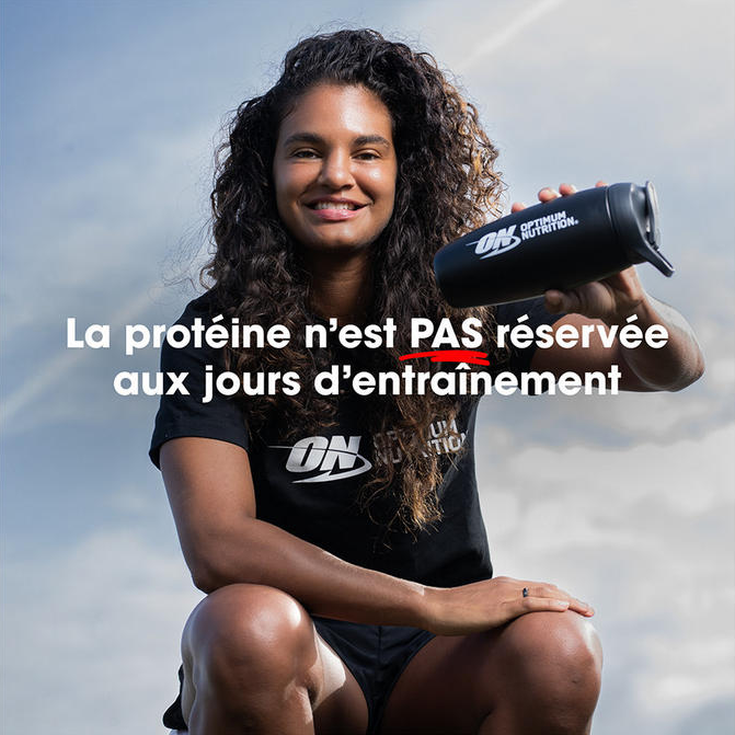 Optimum Nutrition shaker bottle held by a person, promoting protein use beyond workout days