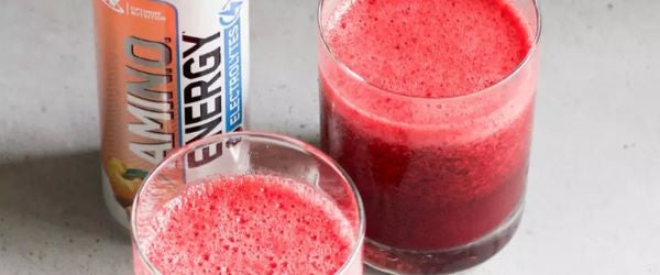 Amino Energy Electrolytes drink with two glasses filled with a red beverage