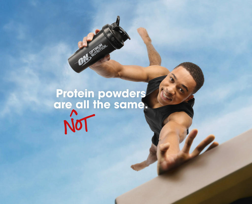 Optimum Nutrition shaker bottle held by a person reaching out, emphasizing unique protein powder qualities