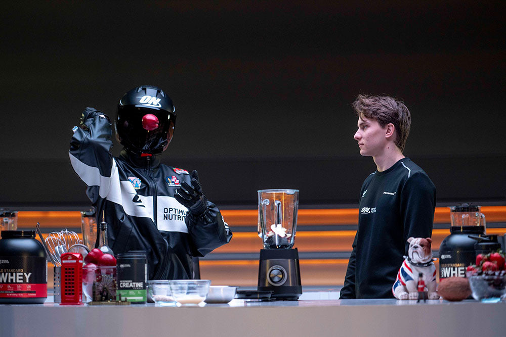Optimum Nutrition products including whey protein powder and creatine displayed on a counter with a blender