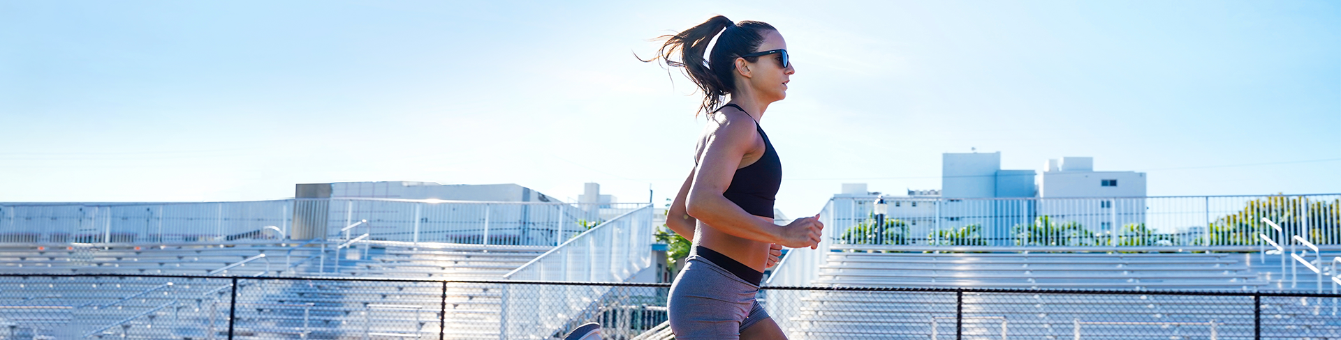 A woman jogging on a track, possibly engaging in a fitness routine