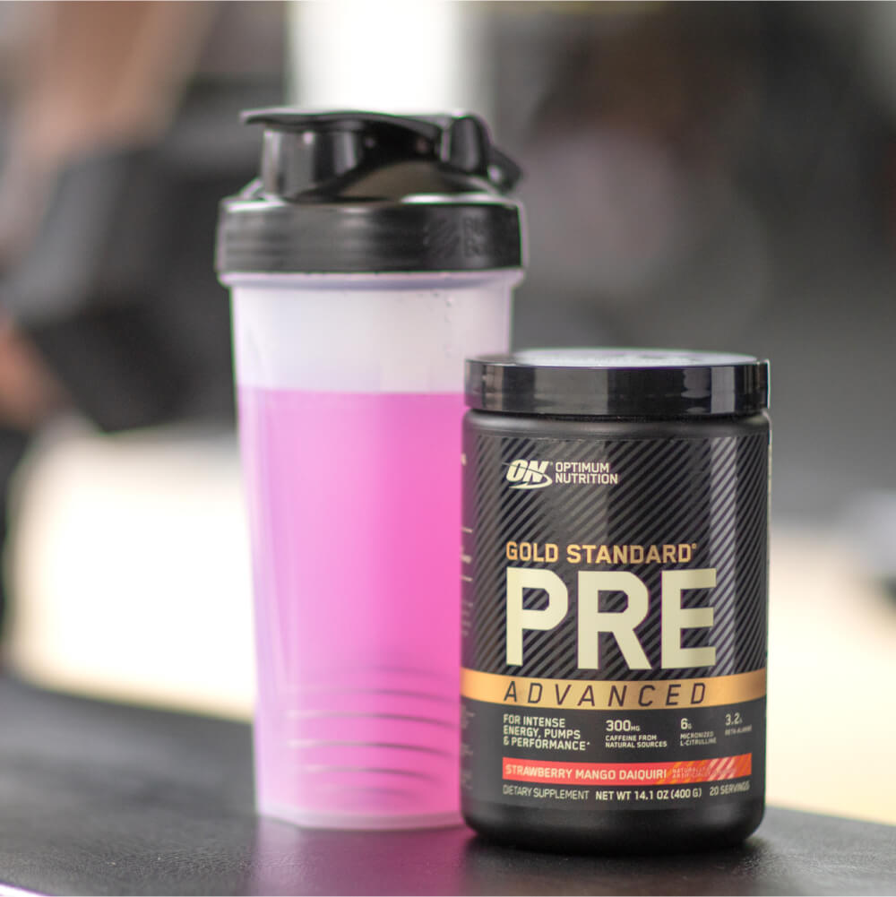 tub of optimum nutrition gold standard pre advanced pre workout with shaker in background