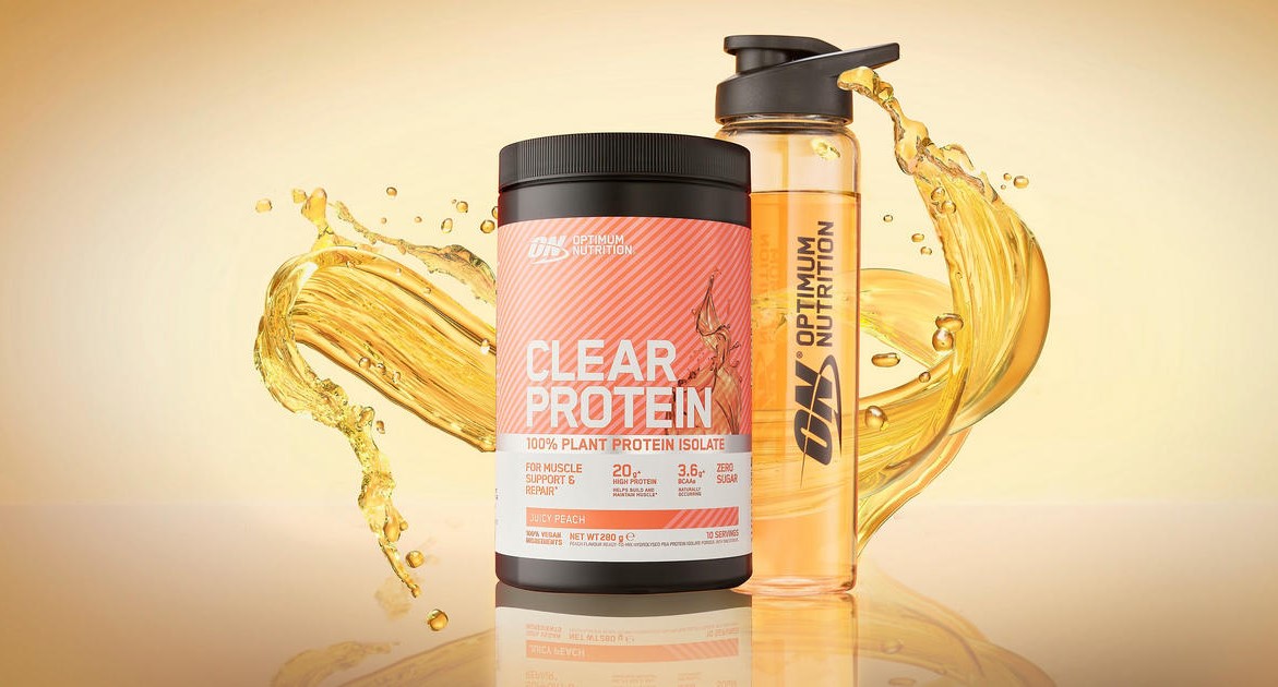 Optimum Nutrition Clear Protein Juicy Peach tub and branded shaker bottle with peach-colored liquid splash in background.
