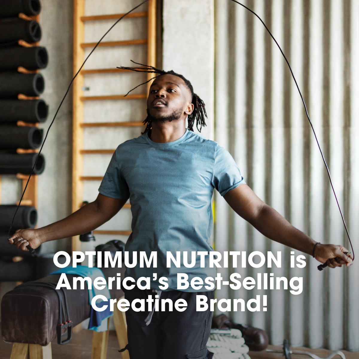 Man skipping rope in a gym with Optimum Nutrition advertisement text overlay