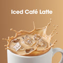 A white ceramic mug filled with iced café latte, with a dramatic splash of creamy coffee and clear ice cubes. The words 'Iced Café Latte' appear in white text at the top against a warm tan background.