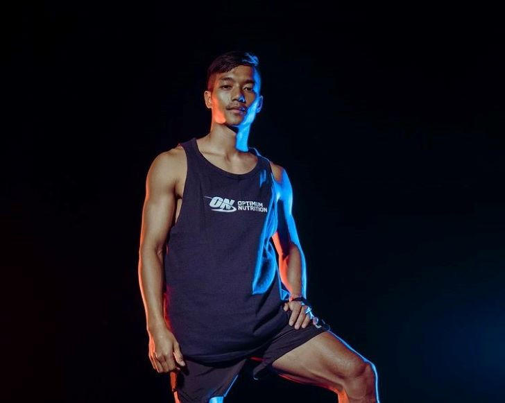 Man wearing Optimum Nutrition branded athletic wear, posing confidently