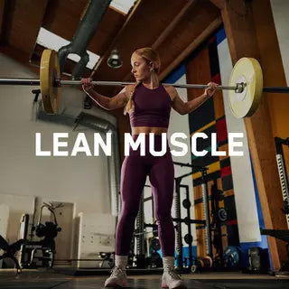 Woman lifting barbell in gym, focusing on building lean muscle through high-intensity workouts