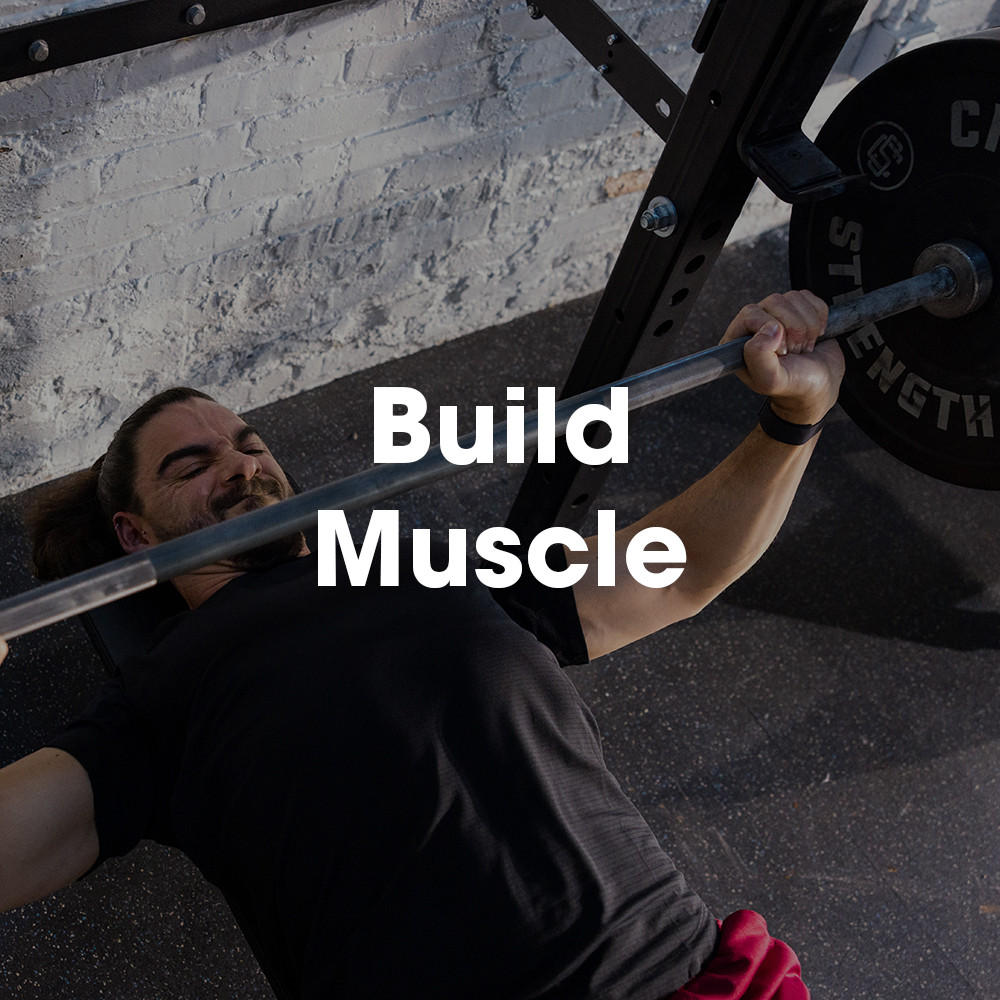 Person performing a bench press exercise with a barbell in a gym setting