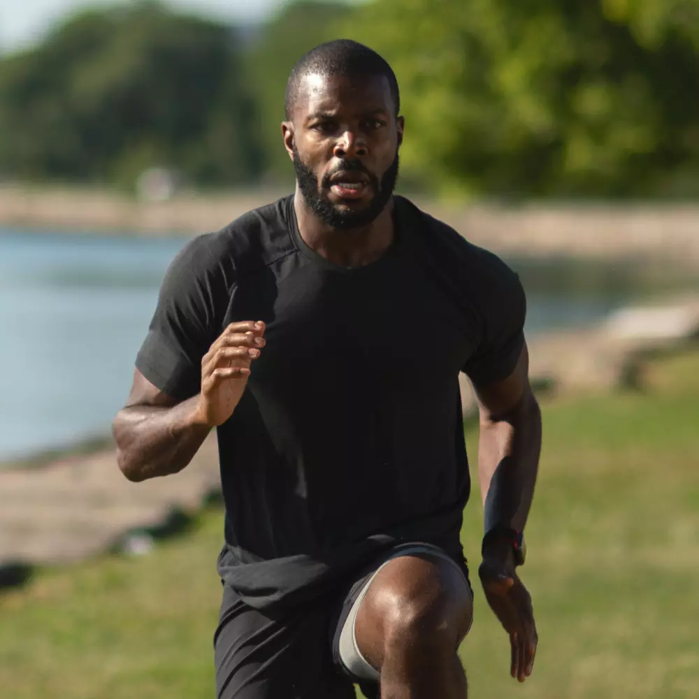 A man running outdoors, possibly engaging in high-intensity workouts, which may benefit from post-workout nutrition like protein shakes or s