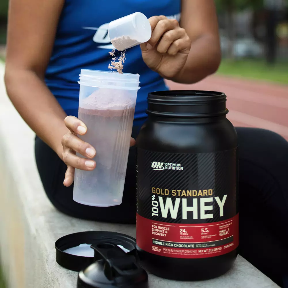 Optimum Nutrition Gold Standard 100% Whey protein powder, Double Rich Chocolate flavor, being prepared in a shaker bottle