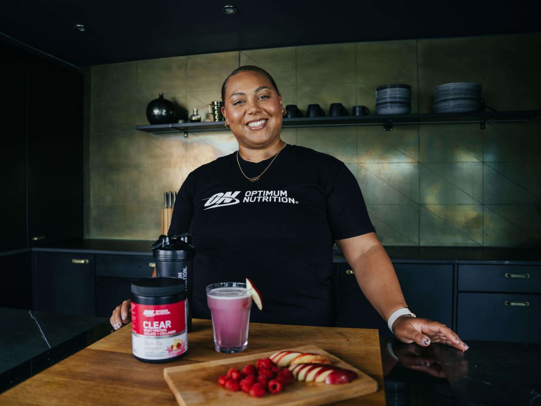 Optimum Nutrition representative with ON Clear Whey Isolate and a prepared protein shake on a kitchen counter