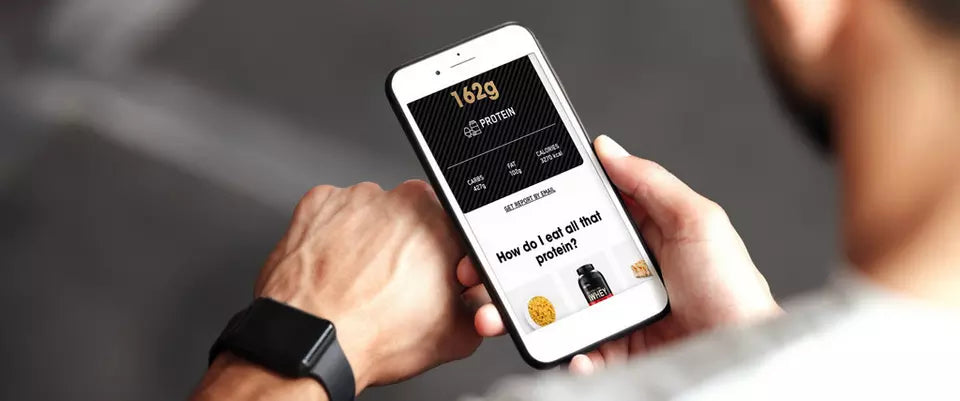 Man using a protein calculator app on a smartphone to determine daily protein intake for muscle building and weight management