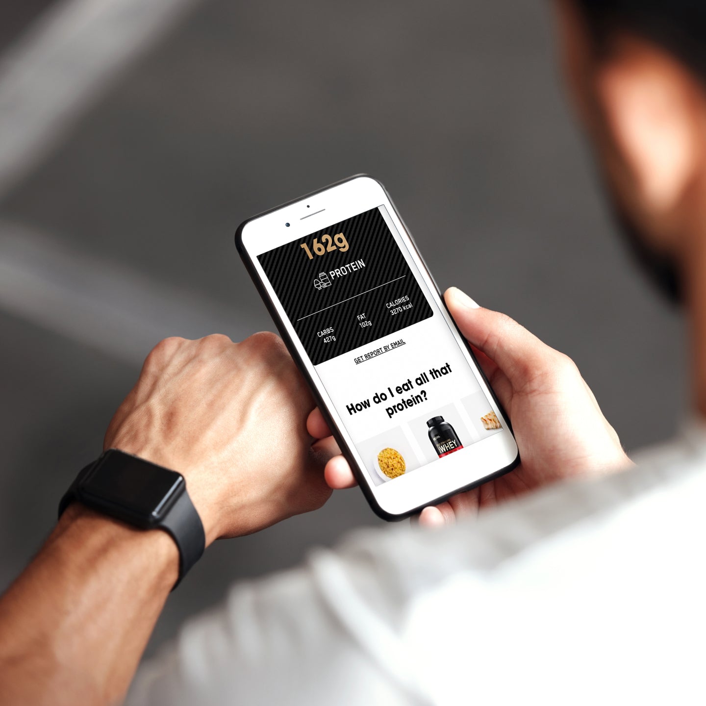 Person holding a smartphone displaying a protein calculator app, possibly related to protein intake or muscle gain