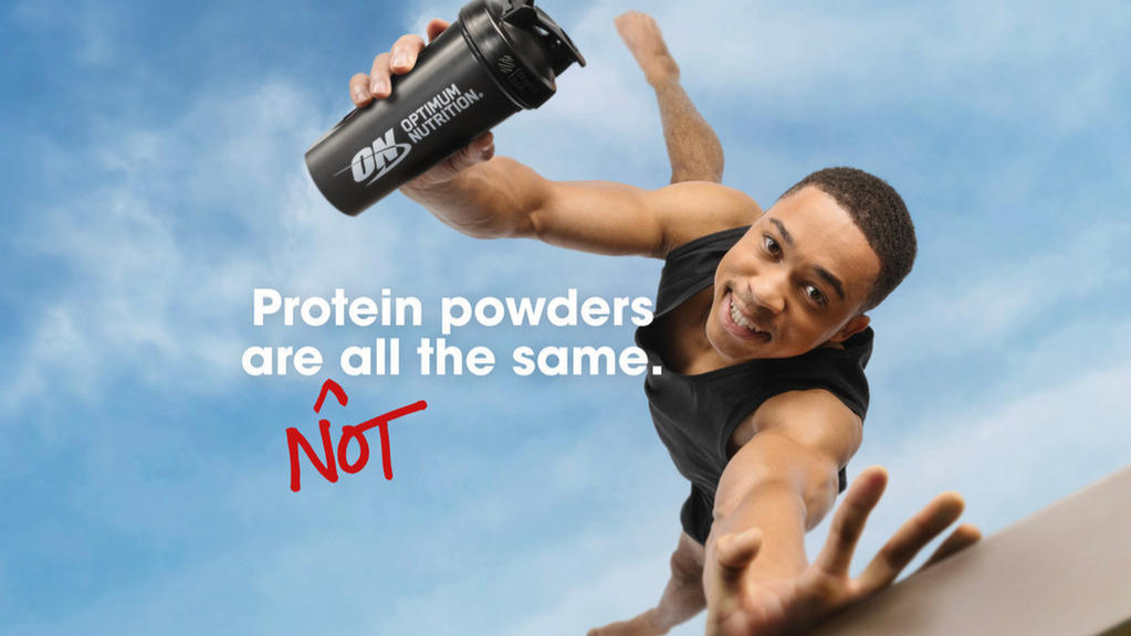 Optimum Nutrition shaker bottle held by a person, promoting protein supplements for post-workout nutrition