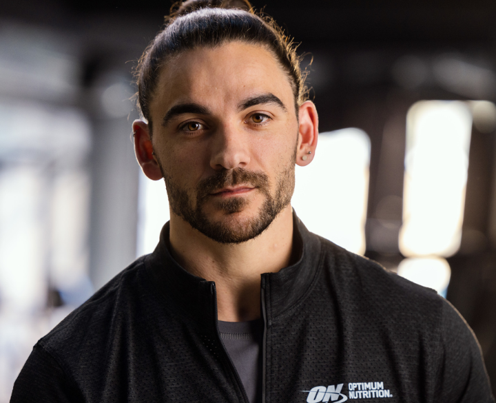 Optimum Nutrition logo on a jacket worn by a person, associated with fitness and nutrition products