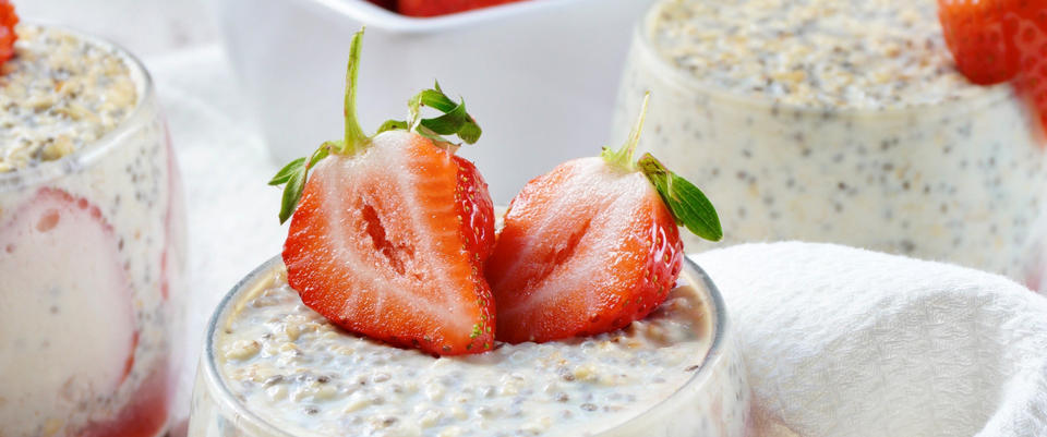 Chia seed pudding topped with sliced strawberries in glass cups