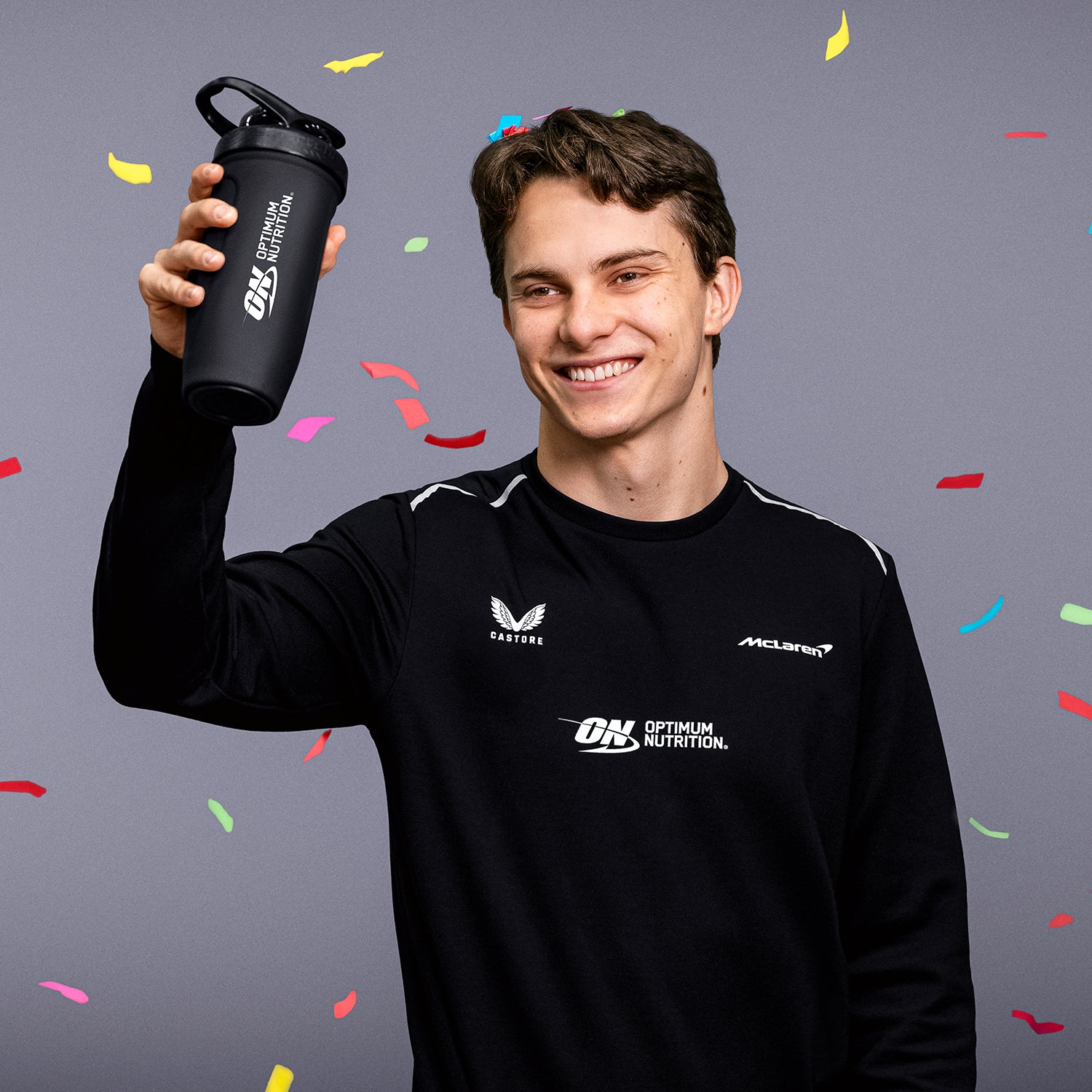 Optimum Nutrition branded shaker bottle held by a person, suitable for protein shakes and post-workout nutrition