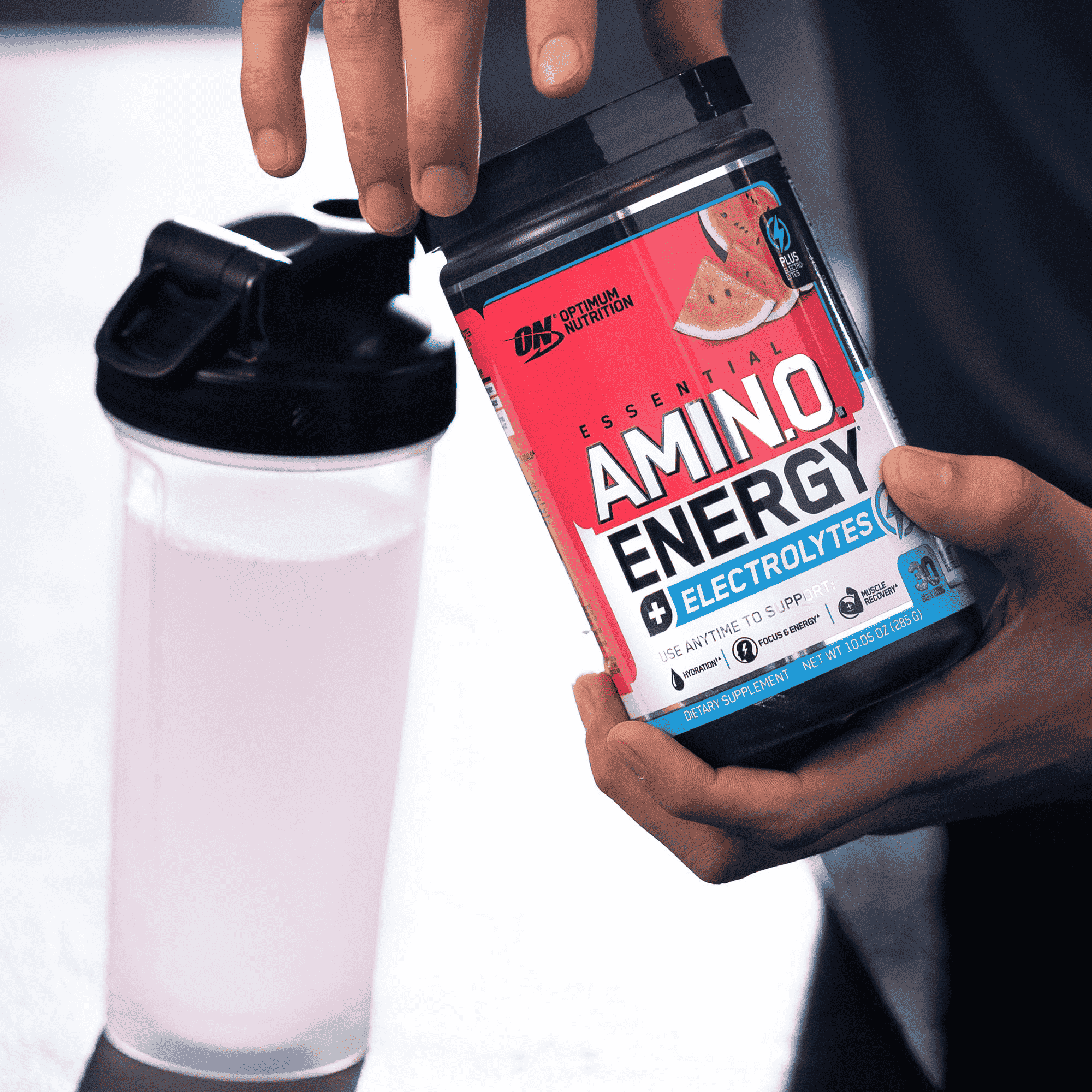 Optimum Nutrition Essential Amino Energy Electrolytes container held next to a shaker bottle