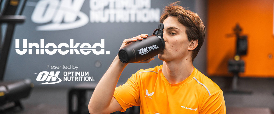 Person drinking from an Optimum Nutrition shaker bottle in a gym setting