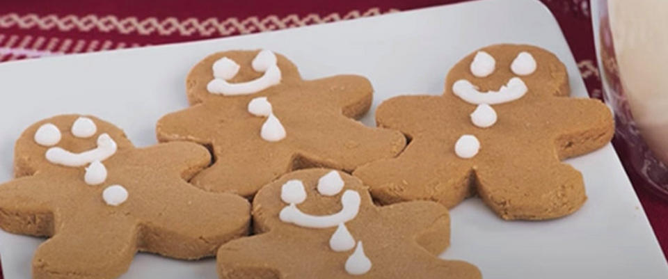 Gingerbread cookies with icing details on a white plate