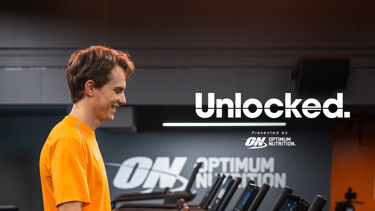 Man exercising on a treadmill at a gym with Optimum Nutrition branding in the background