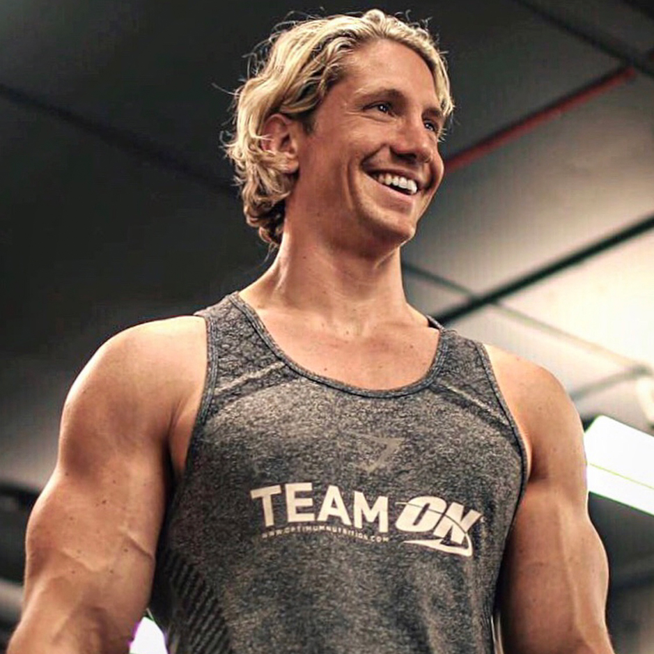 man smiling in the gym with optimum nutrition activewear on