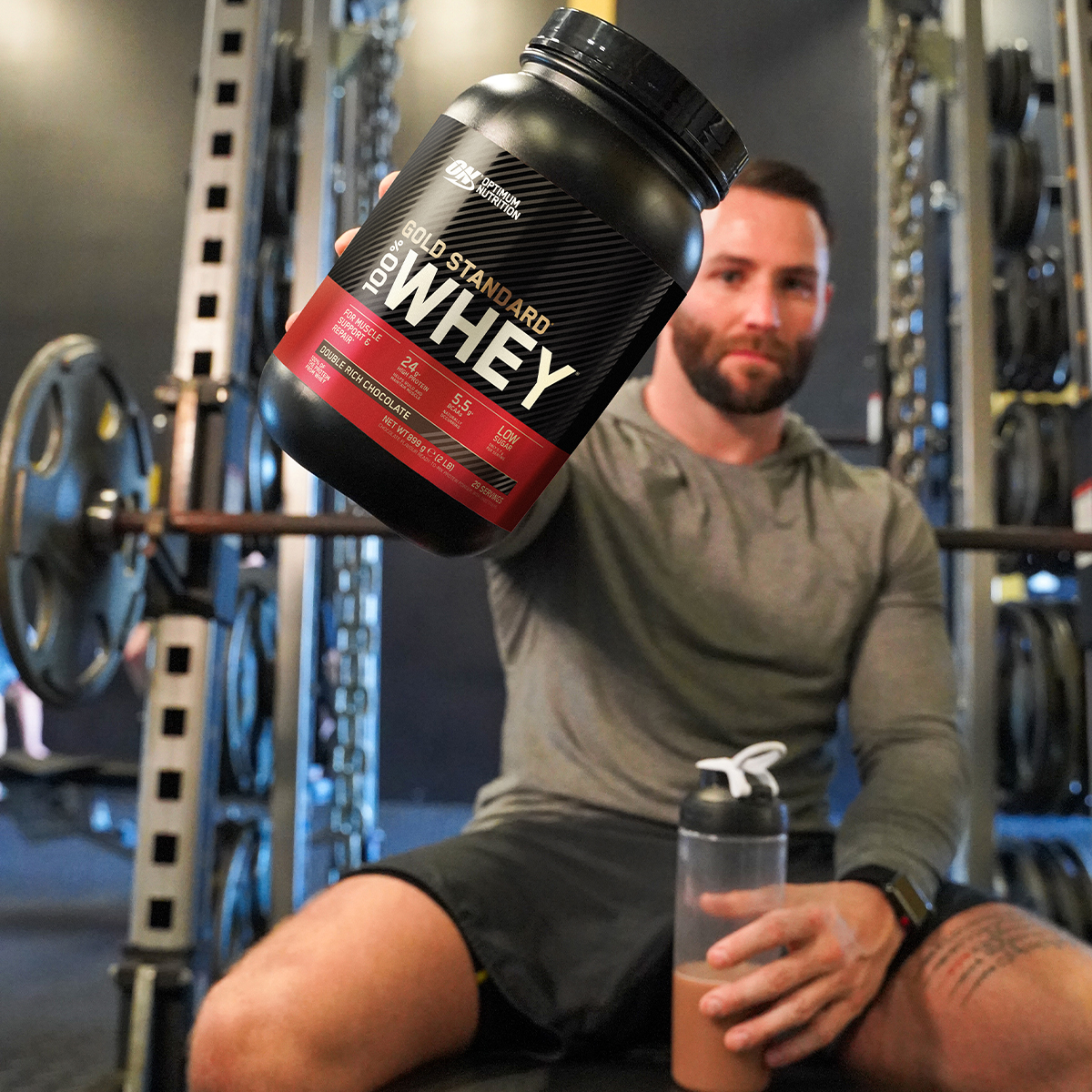 man holding tub of optimum nutrition gold standard 100% whey