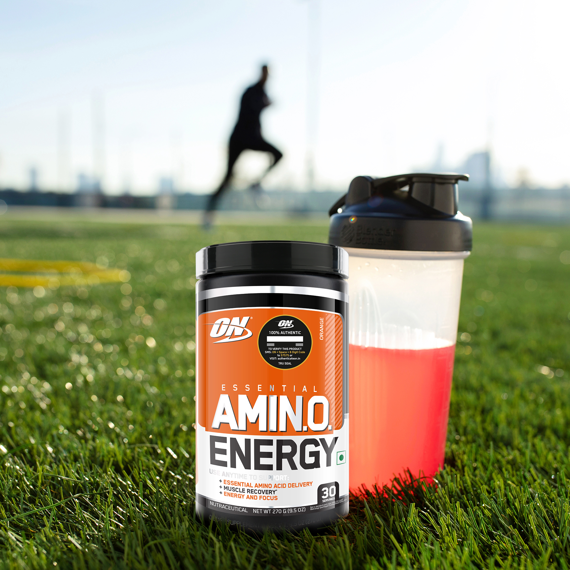 tub of optimum nutrition amino energy with shaker and man running in background