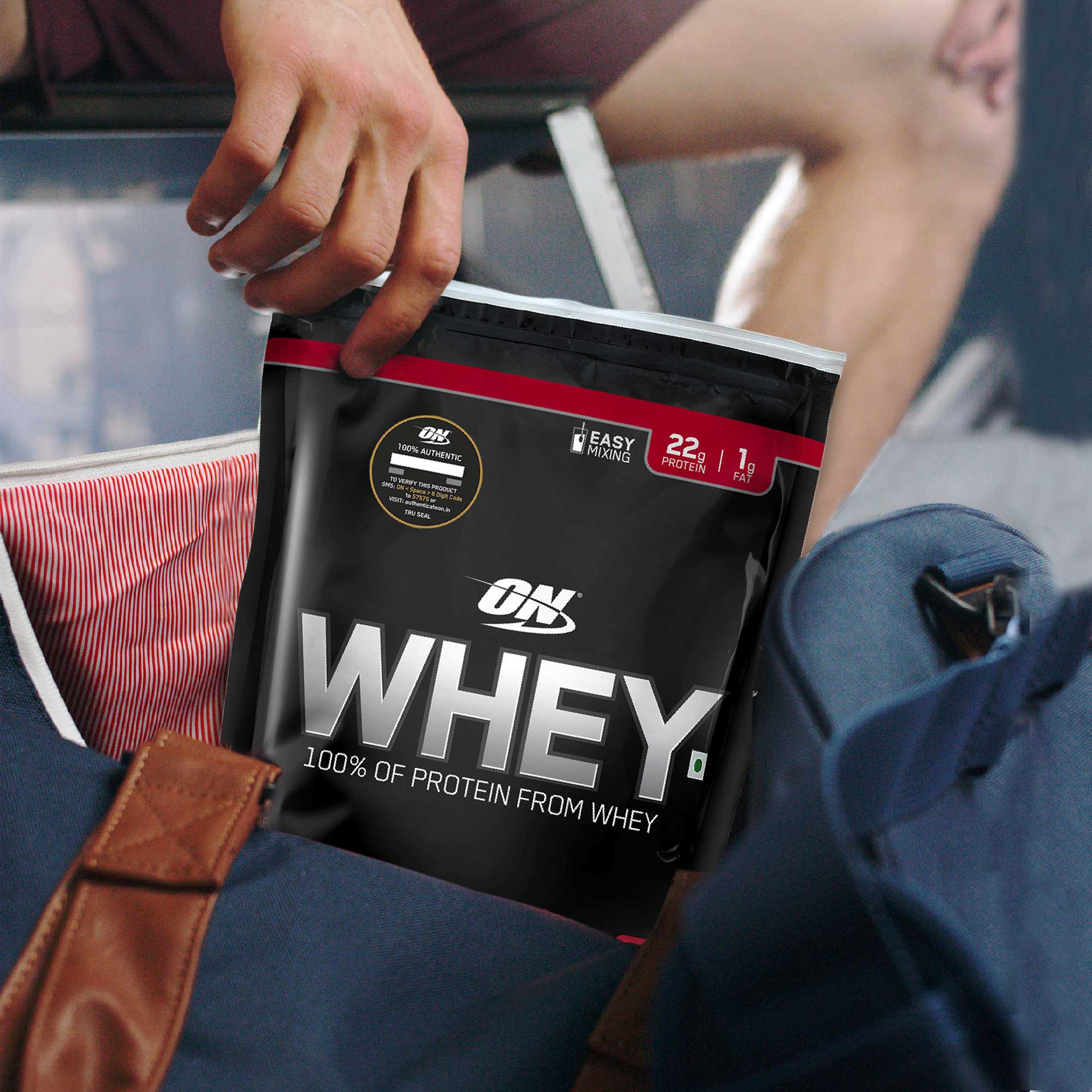 person holding pouch of optimum nutrition ON whey